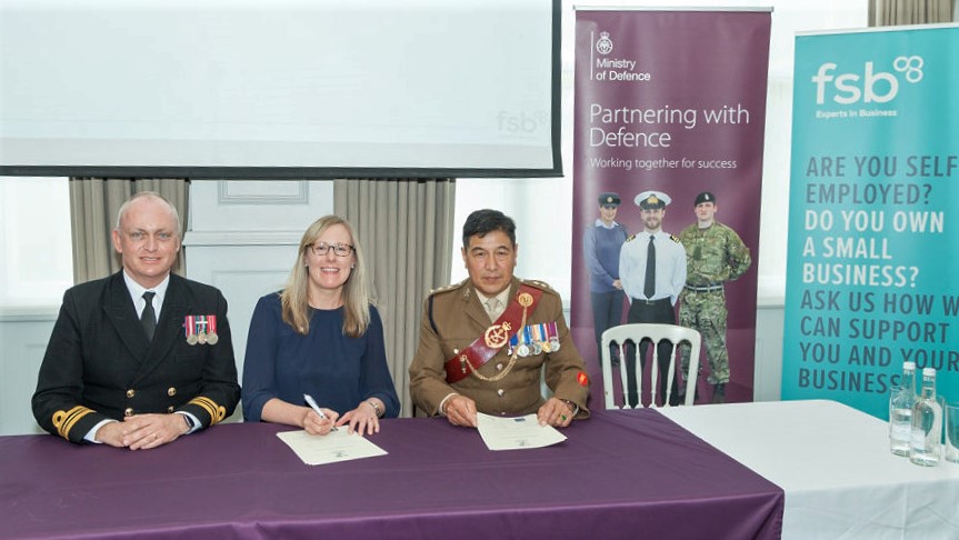 Debbie Scott, co-founder and director of Scott Communications, signing the Armed Forces Covenant